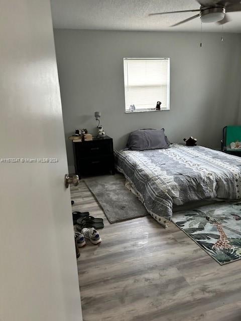 bedroom featuring hardwood / wood-style flooring and ceiling fan