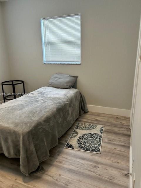 bedroom with wood-type flooring