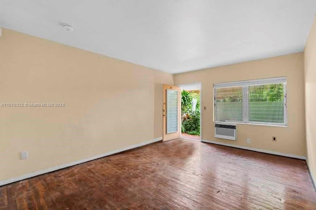 empty room with baseboards and wood finished floors