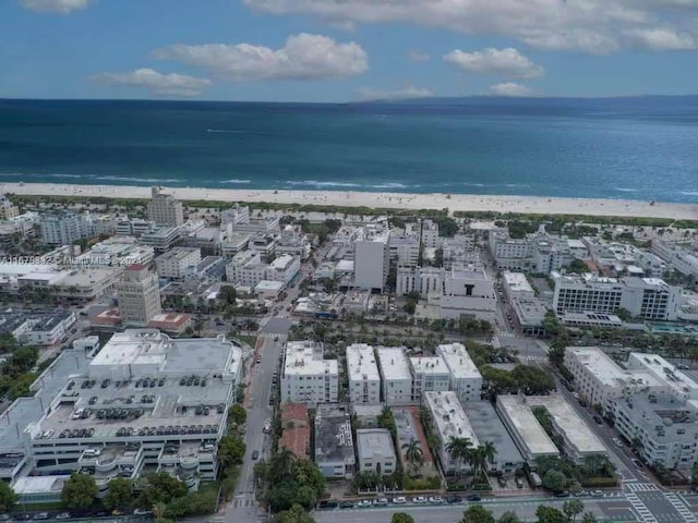 birds eye view of property with a view of the beach and a water view