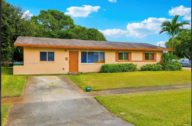 ranch-style home with a front lawn