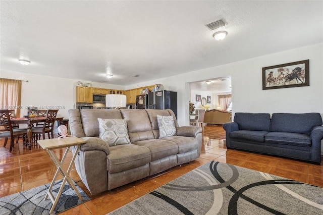 tiled living room with a textured ceiling