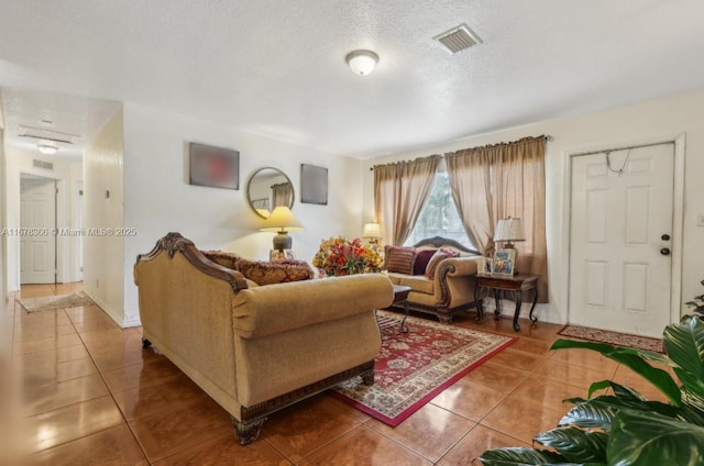 tiled living room with a textured ceiling