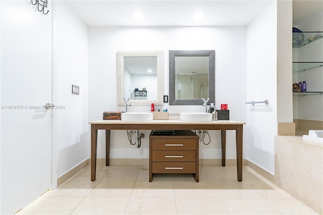 bathroom featuring tile patterned flooring, sink, and walk in shower