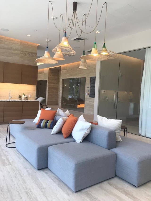 living room featuring sink and light hardwood / wood-style floors