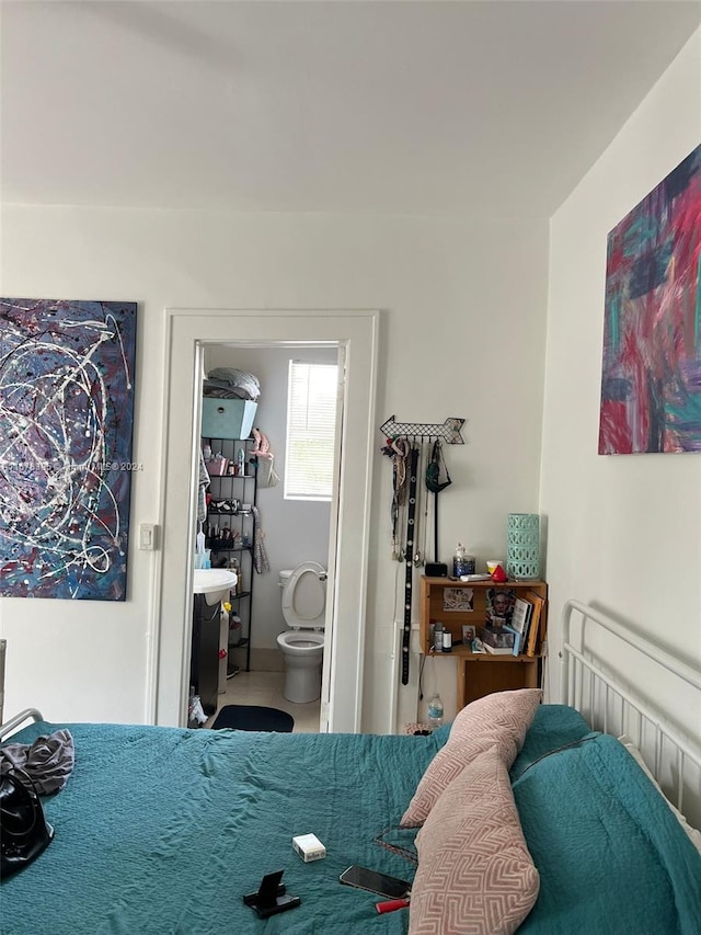 tiled bedroom featuring connected bathroom