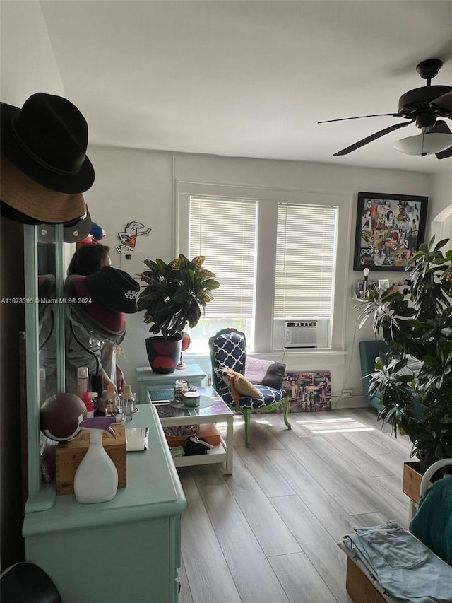 interior space with ceiling fan, wood-type flooring, and cooling unit