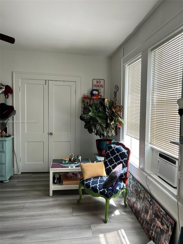 living area featuring light hardwood / wood-style floors and cooling unit