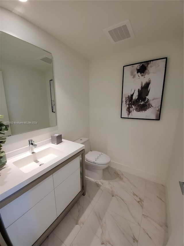 bathroom featuring vanity and toilet