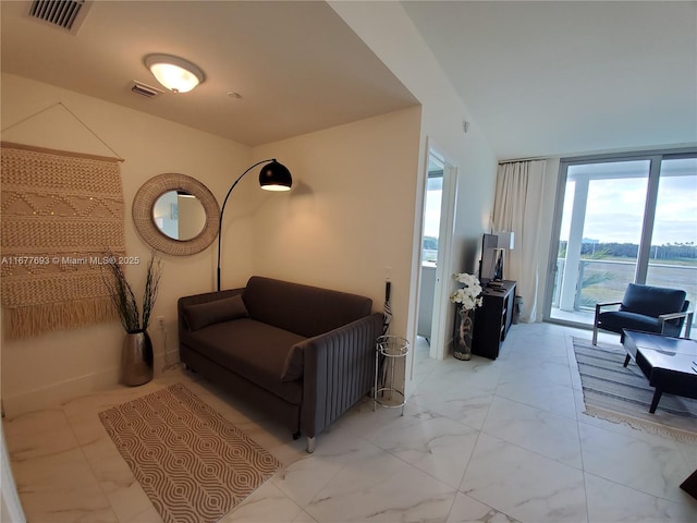 living area with marble finish floor and visible vents