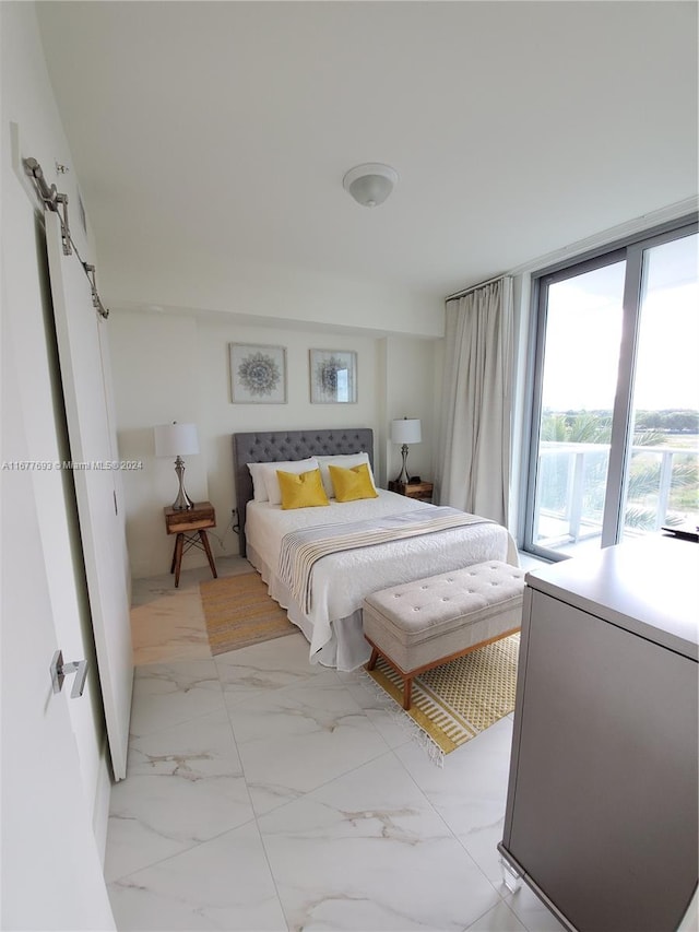 bedroom with access to outside and a barn door