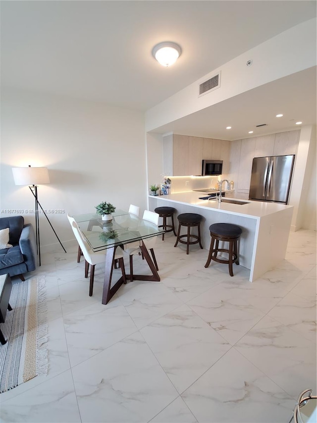 dining room featuring marble finish floor, visible vents, and recessed lighting