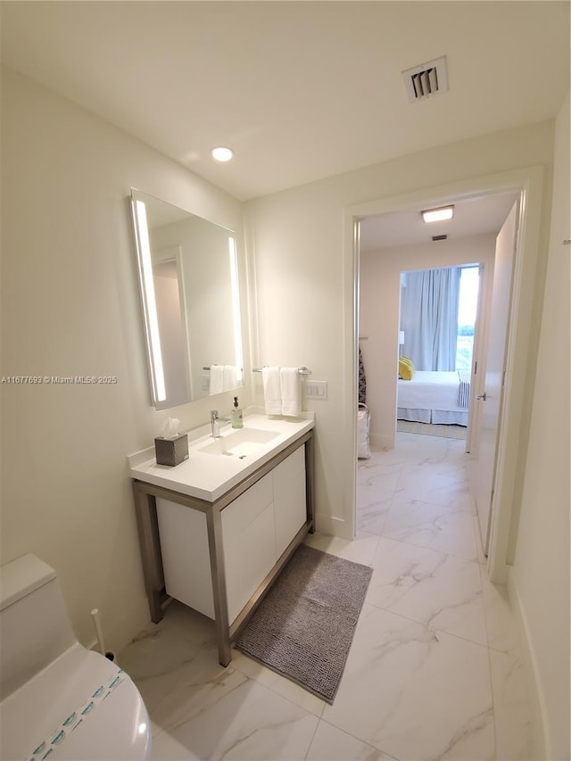 ensuite bathroom with marble finish floor, visible vents, toilet, ensuite bathroom, and vanity