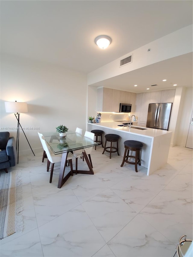 dining area with marble finish floor, visible vents, and recessed lighting