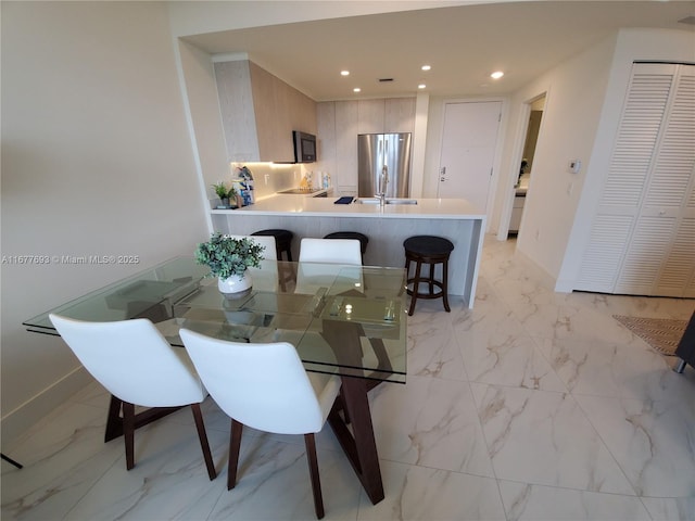 dining space with recessed lighting, marble finish floor, and baseboards