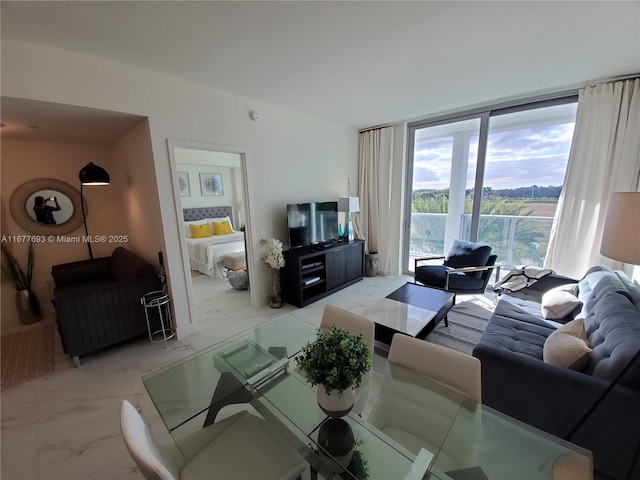 living area with expansive windows and marble finish floor