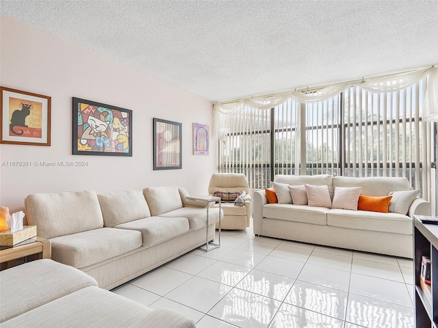 living room with a textured ceiling and light tile patterned floors