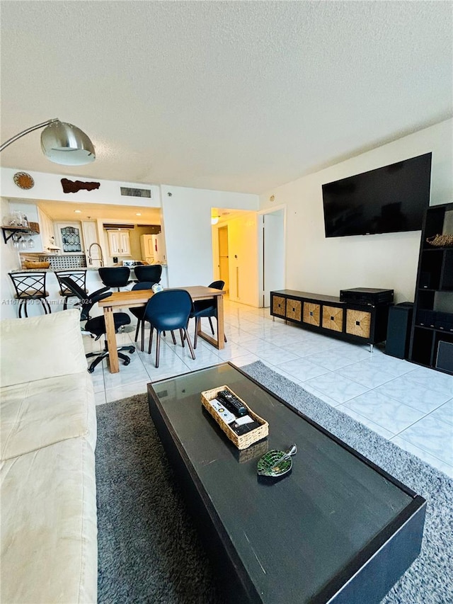 tiled living room with a textured ceiling