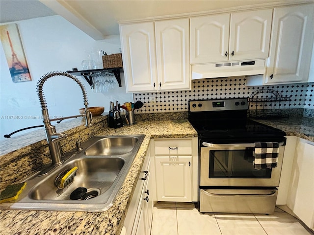 kitchen with decorative backsplash, dark stone counters, sink, white cabinets, and stainless steel electric range oven