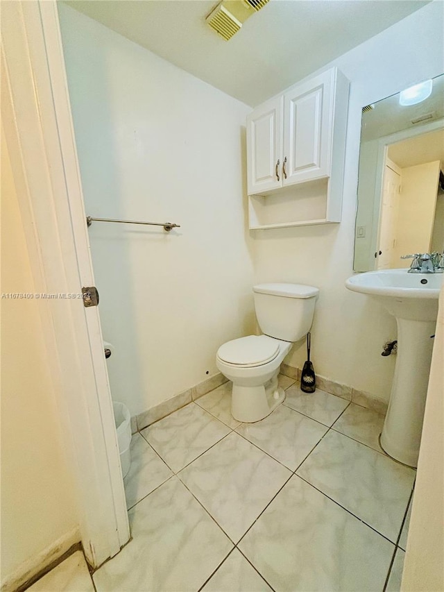 bathroom featuring toilet and tile patterned floors