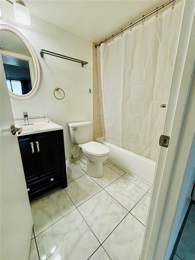 full bathroom featuring vanity, toilet, tile patterned floors, and shower / bath combination with curtain