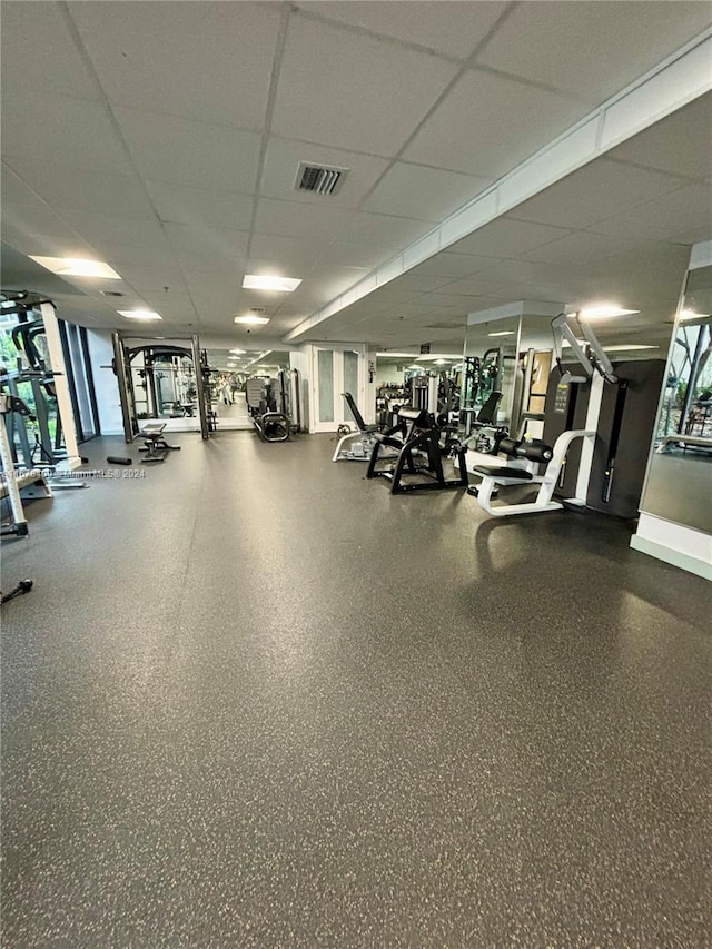 workout area with a paneled ceiling