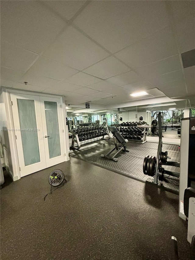 exercise room featuring a drop ceiling and a healthy amount of sunlight