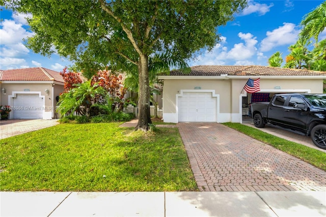 mediterranean / spanish house featuring a front lawn and a garage