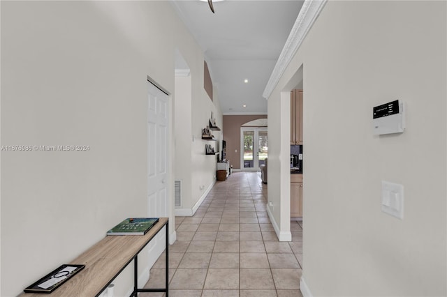 hall featuring crown molding, french doors, and light tile patterned floors