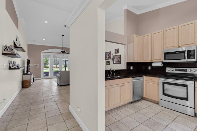 kitchen featuring light tile patterned flooring, crown molding, stainless steel appliances, and sink