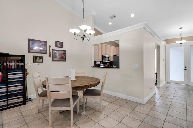 dining area featuring light tile patterned flooring, ornamental molding, and an inviting chandelier