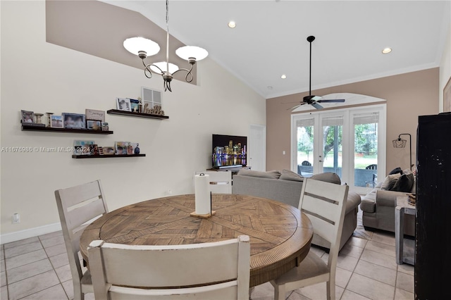 dining room featuring lofted ceiling, light tile patterned floors, crown molding, ceiling fan with notable chandelier, and french doors