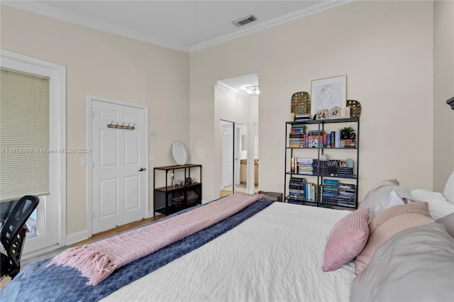 bedroom with crown molding and wood-type flooring