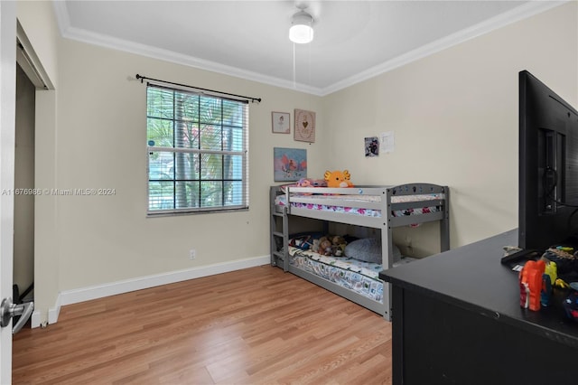 bedroom featuring light hardwood / wood-style floors and crown molding