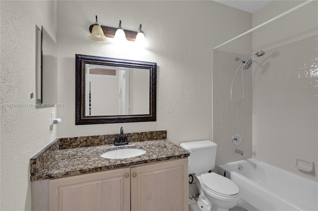 full bathroom featuring vanity, tiled shower / bath combo, and toilet