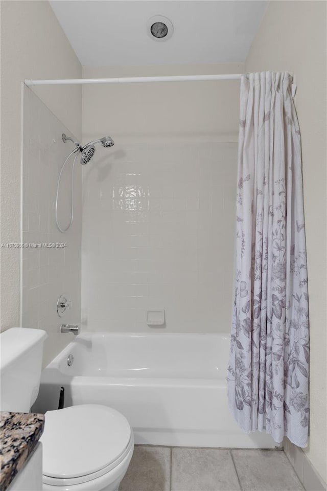 full bathroom with toilet, vanity, tile patterned floors, and shower / tub combo