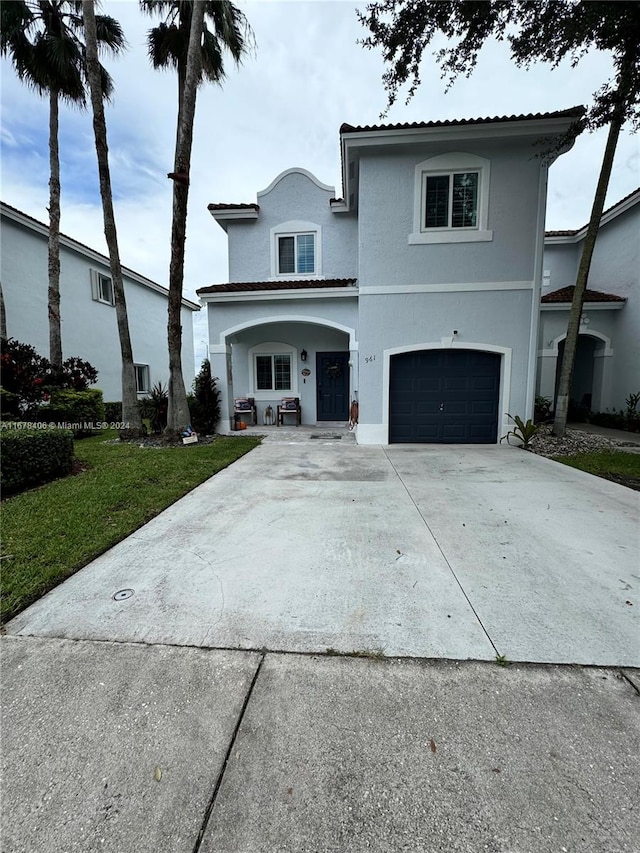 view of front property with a front yard and a garage