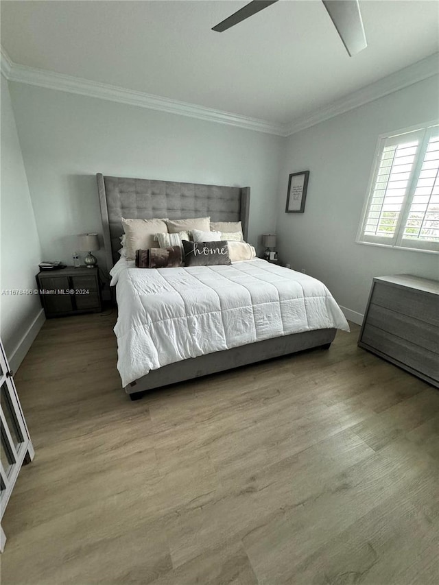 bedroom with ceiling fan, hardwood / wood-style flooring, and ornamental molding