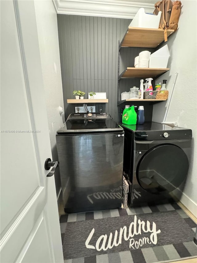 washroom featuring crown molding and separate washer and dryer