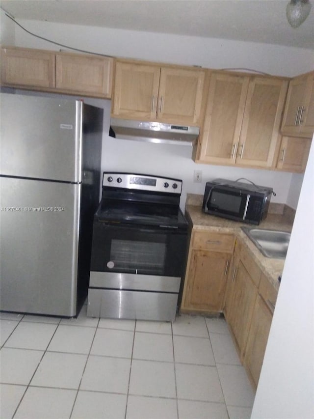 496 NW 165th St Rd Unit D-410, Miami, FL 33169 - kitchen with stainless steel appliances, light brown cabinetry, light tile patterned flooring, light countertops, and under cabinet range hood