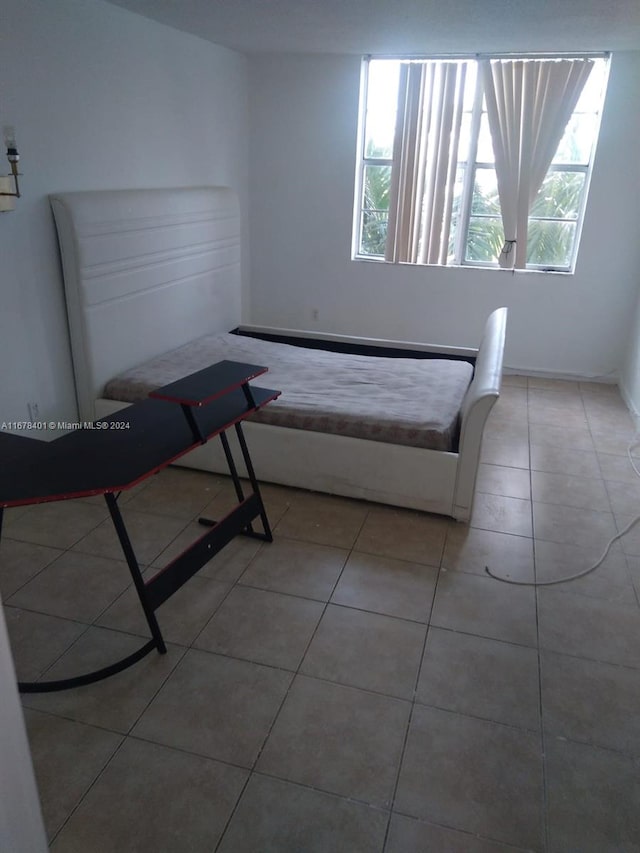 496 NW 165th St Rd Unit D-410, Miami, FL 33169 - bedroom with tile patterned floors and multiple windows