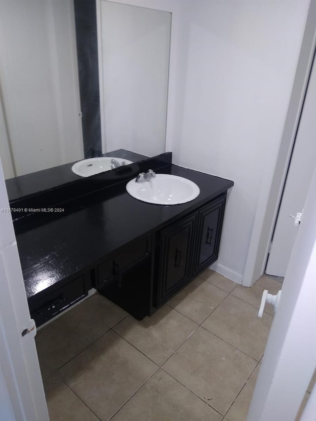 bathroom with tile patterned floors and vanity