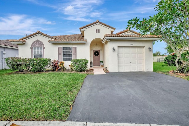 mediterranean / spanish-style home with a front yard and a garage