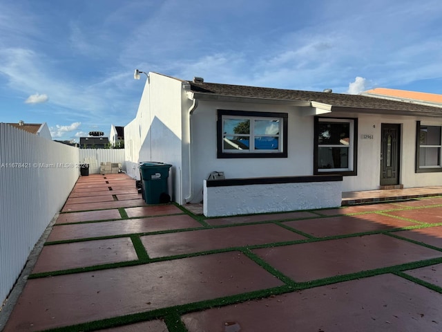 view of side of property with a patio area