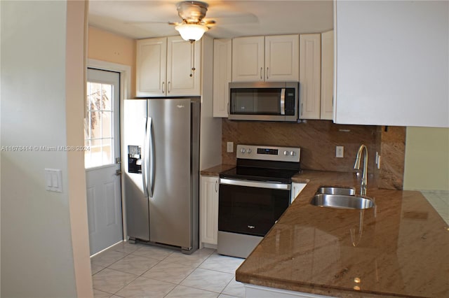 kitchen featuring stainless steel appliances, sink, stone counters, white cabinetry, and ceiling fan