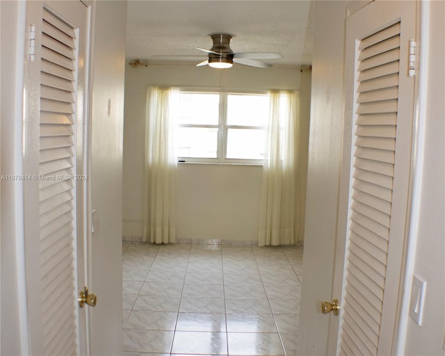 hall with a textured ceiling