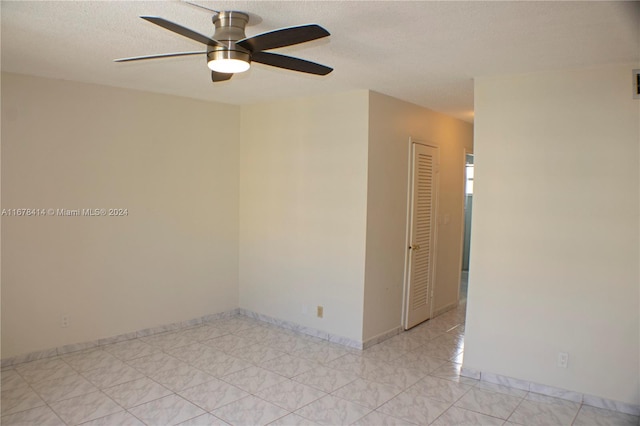 empty room featuring a textured ceiling and ceiling fan