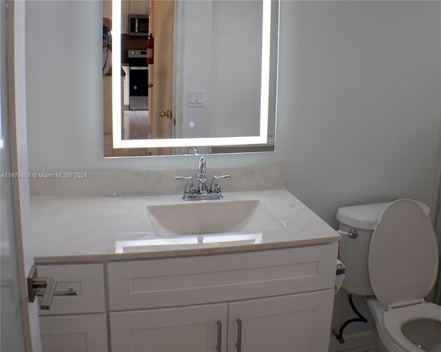 bathroom featuring vanity and toilet