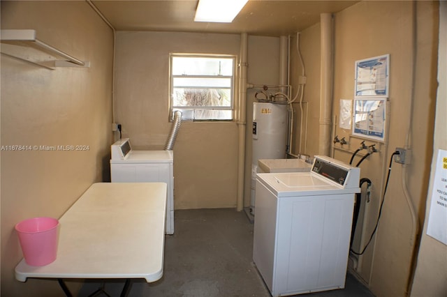 washroom featuring washing machine and dryer and water heater