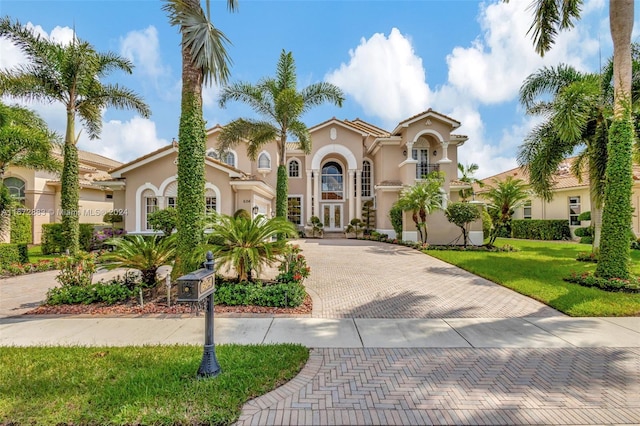 mediterranean / spanish-style house with a front lawn